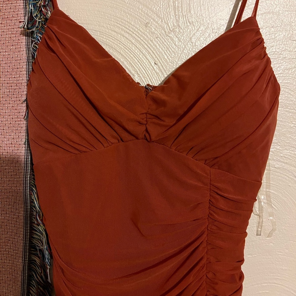 Long scrunch auburn dress with short slit on the bottom.